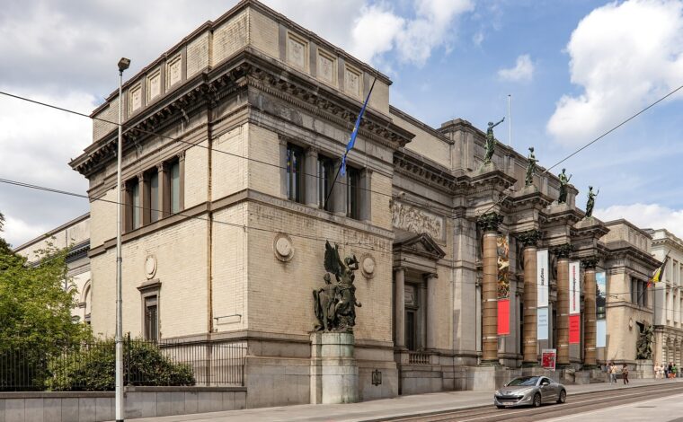 Royal Museums of Fine Arts of Belgium in Brussels, with bronze sculptures, entrance banners and tram tracks along the facade.