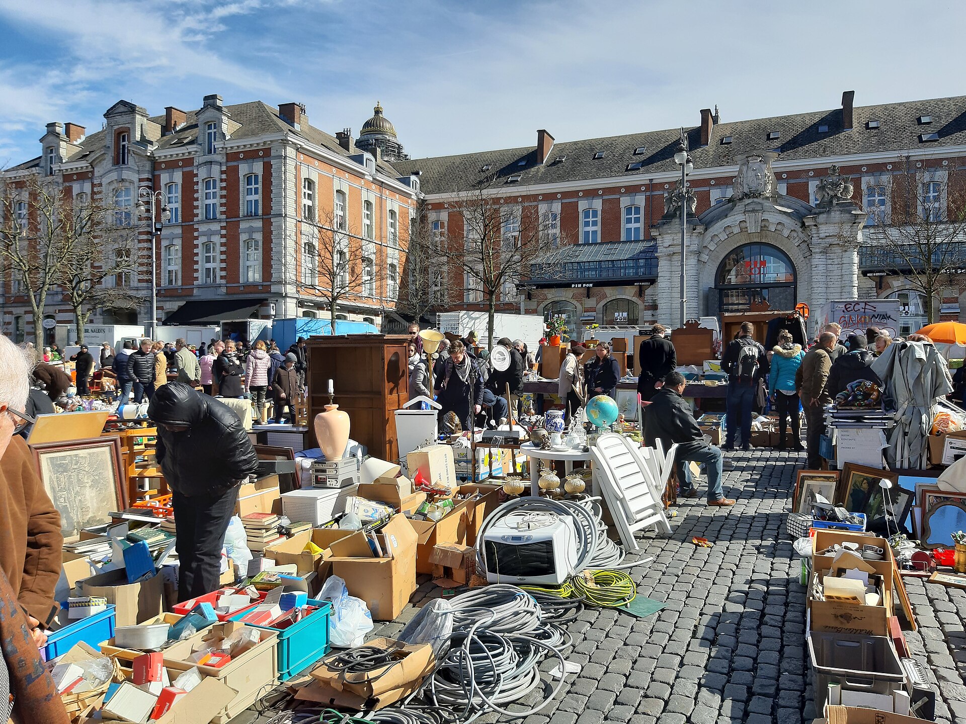 Shoppers browse furniture, pictures and household goods on the cobbles of Place du Jeu de Balle in Brussels, beside the former fire station.